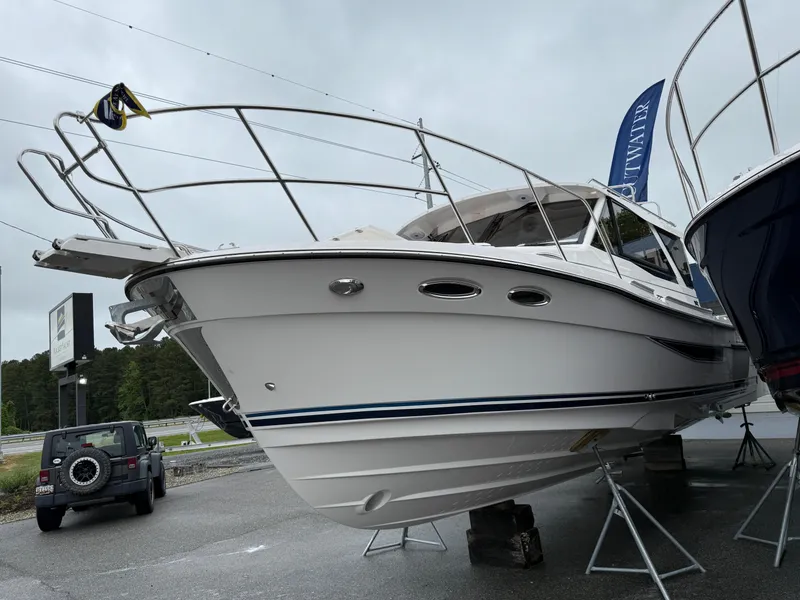 Slide: The Image of 2025 Cutwater C-32 C boat displayed on stands in a parking lot. - 3