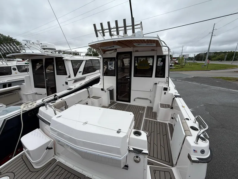 Slide: The Image of 2025 Cutwater C-32 C boat with spacious deck and modern design, docked outdoors. - 5