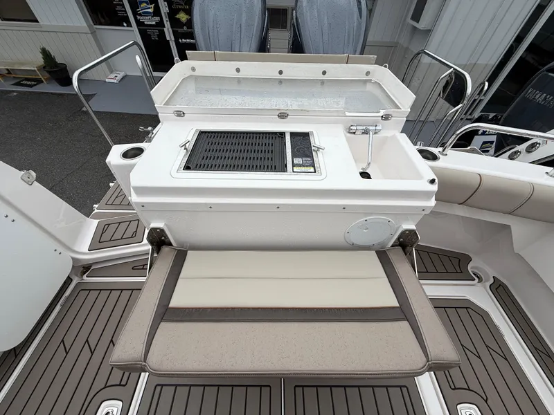 Slide: The Image of 2025 Cutwater C-32 C boat deck with integrated grill and seating area. - 8