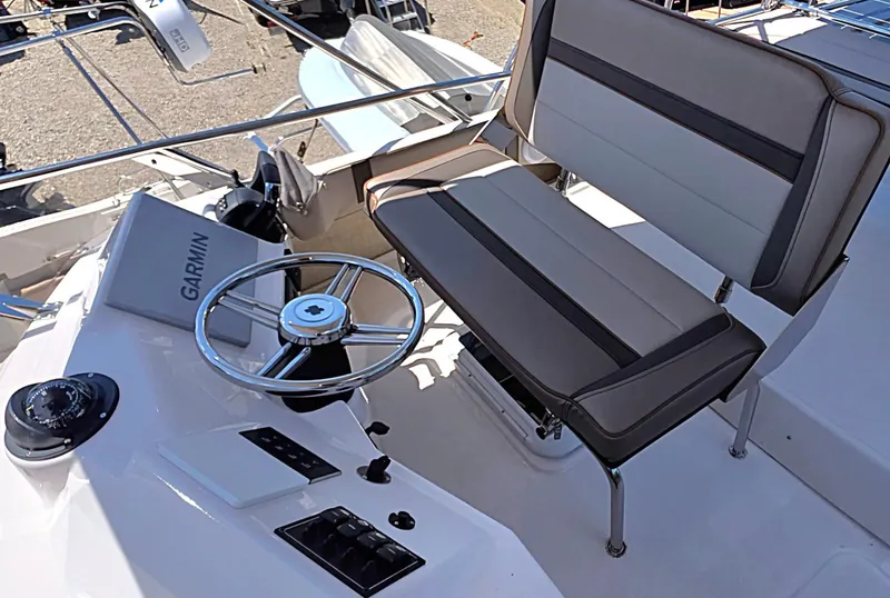 Slide: The Image of 2025 Cutwater C-32 CB helm with Garmin navigation and cushioned seating. - 12
