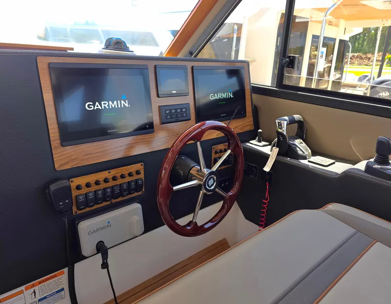 Slide: The Image of Helm of 2025 Cutwater C-32 CB boat with Garmin navigation displays. - 6