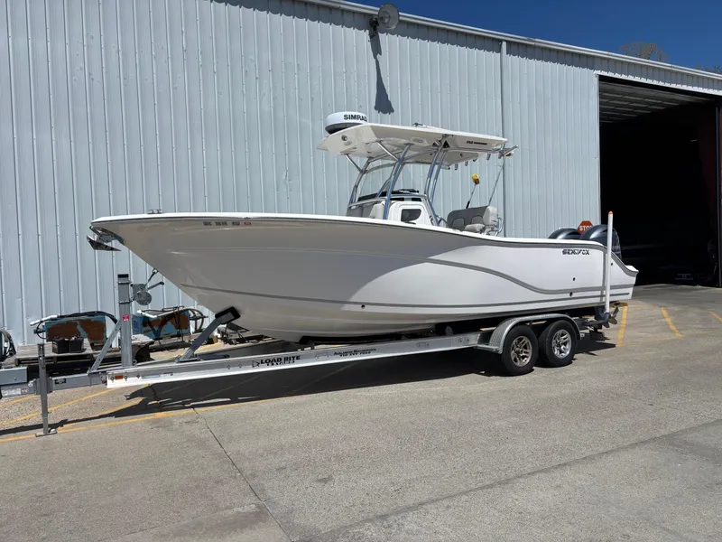 Slide: The Image of 2020 Sea Fox 266 Commander boat on trailer outside a large warehouse. - 0