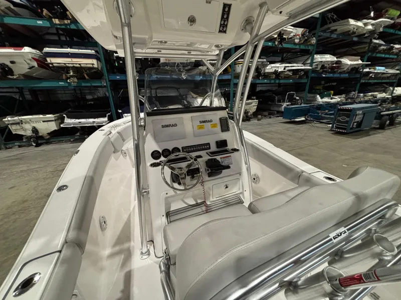 Slide: The Image of 2020 Sea Fox 266 Commander boat interior with steering console and seating in storage facility. - 13