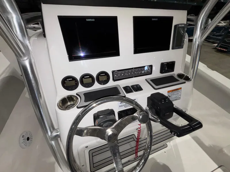 Slide: The Image of 2020 Sea Fox 266 Commander boat dashboard with dual Simrad displays and steering wheel. - 14