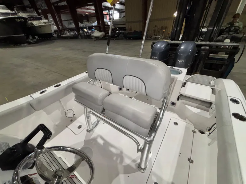 Slide: The Image of 2020 Sea Fox 266 Commander boat interior with dual engines and seating in a warehouse. - 15