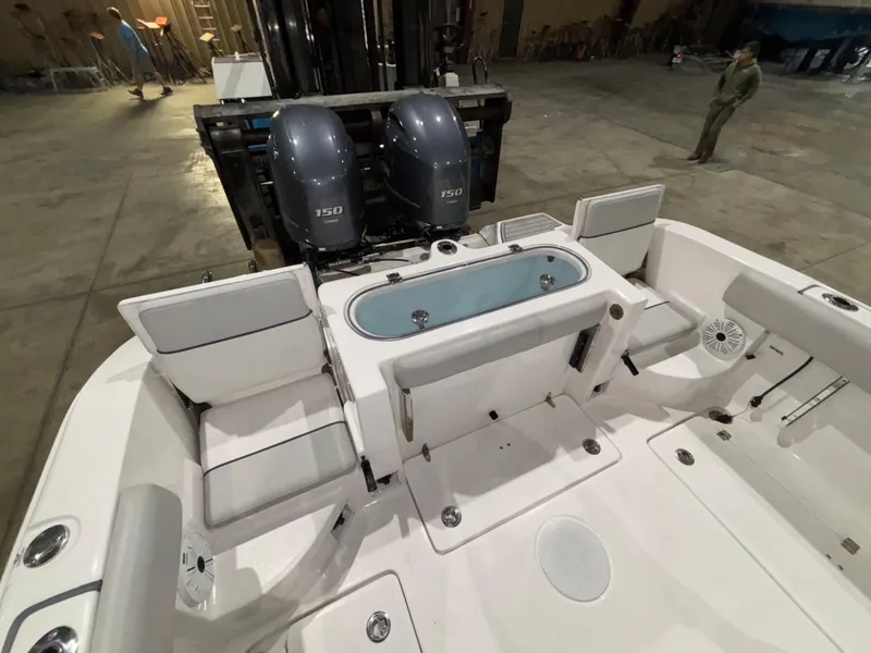 Slide: The Image of 2020 Sea Fox 266 Commander boat interior with dual engines in a warehouse setting. - 21