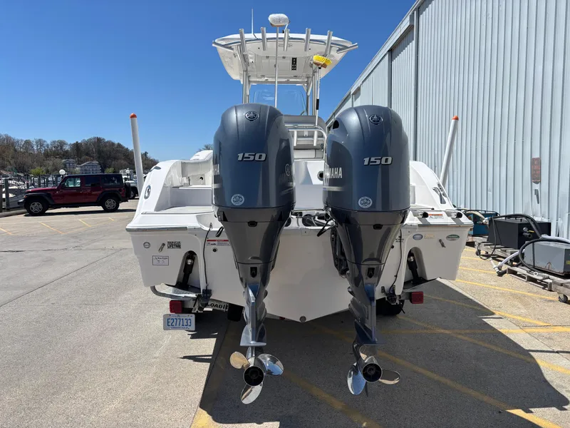 Slide: The Image of 2020 Sea Fox 266 Commander boat with dual Yamaha 150 engines, parked outdoors. - 4