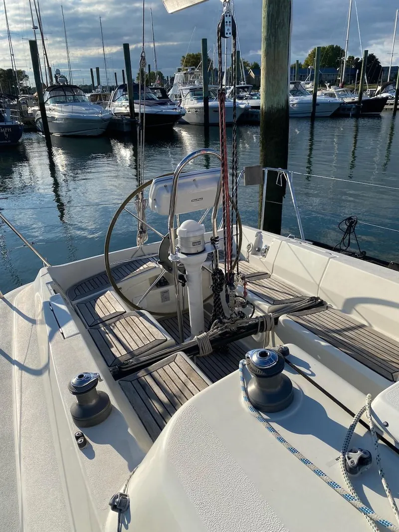 Slide: The Image of 2001 X-Yachts 332 sailboat cockpit with steering wheel, docked in marina. - 12