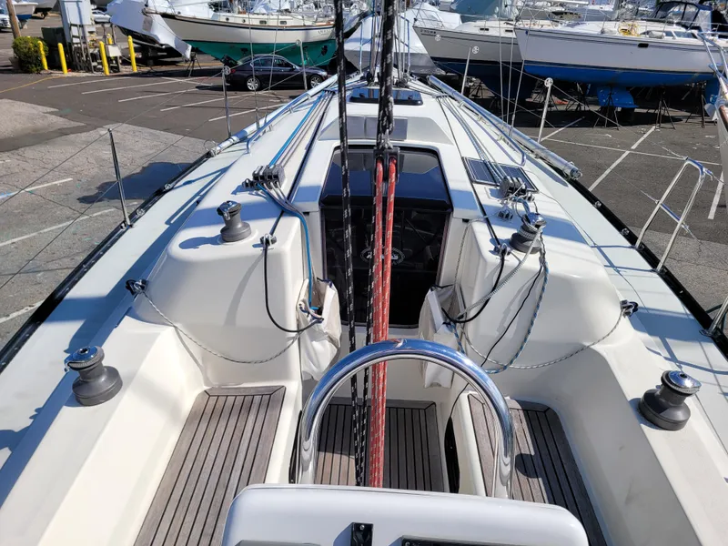 Slide: The Image of 2001 X-Yachts 332 sailboat deck with winches and ropes in a marina setting. - 15