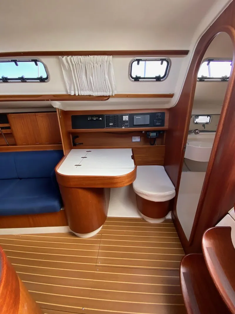 Slide: The Image of Interior of 2001 X-Yachts 332, featuring wooden cabinetry and seating area. - 18