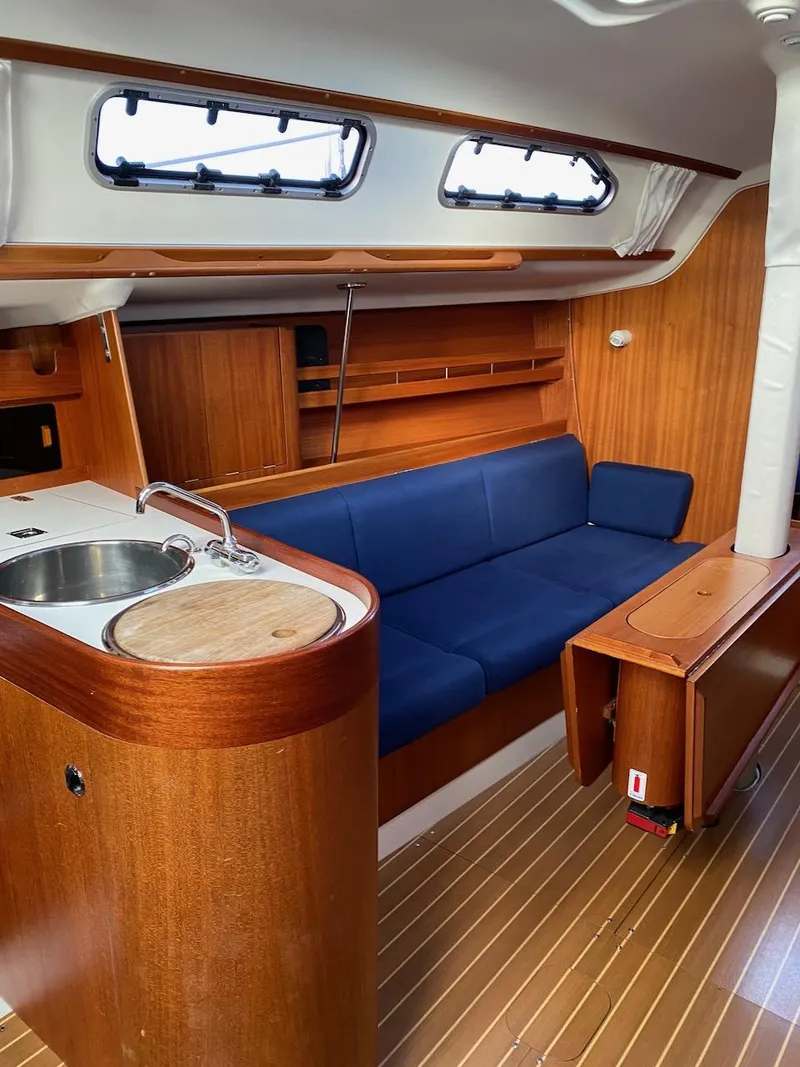 Slide: The Image of Interior of 2001 X-Yachts 332 sailboat with wooden finish and blue seating. - 25