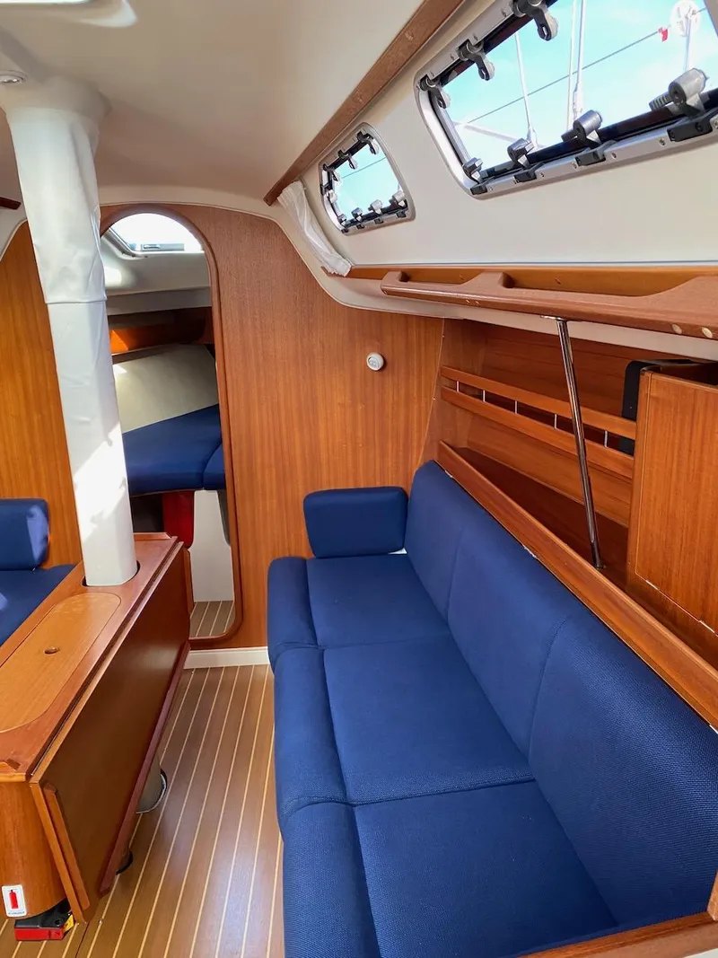 Slide: The Image of Interior of 2001 X-Yachts 332 sailboat with blue seating and wooden finishes. - 26