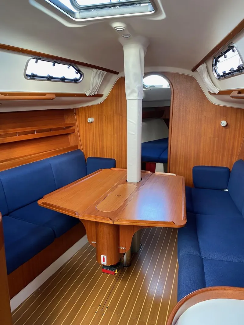 Slide: The Image of Interior of 2001 X-Yachts 332 sailboat with wooden finish and blue seating. - 28