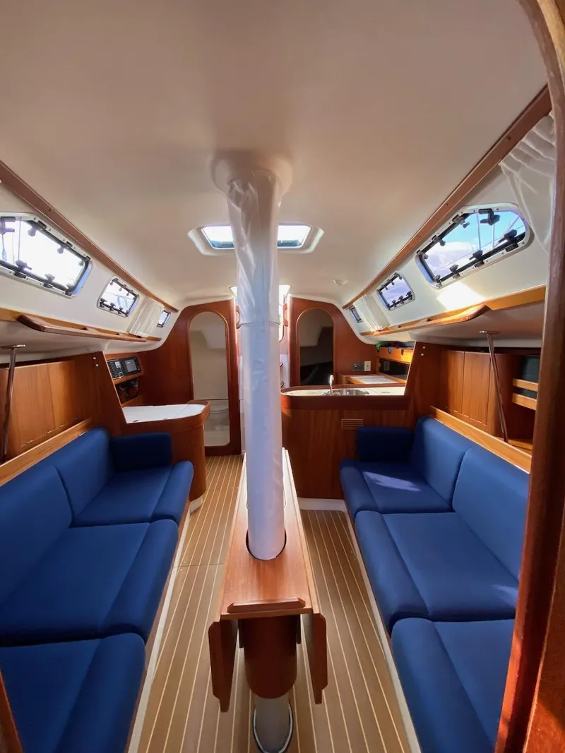 Slide: The Image of Interior of 2001 X-Yachts 332 sailboat with blue seating and wooden finishes. - 30