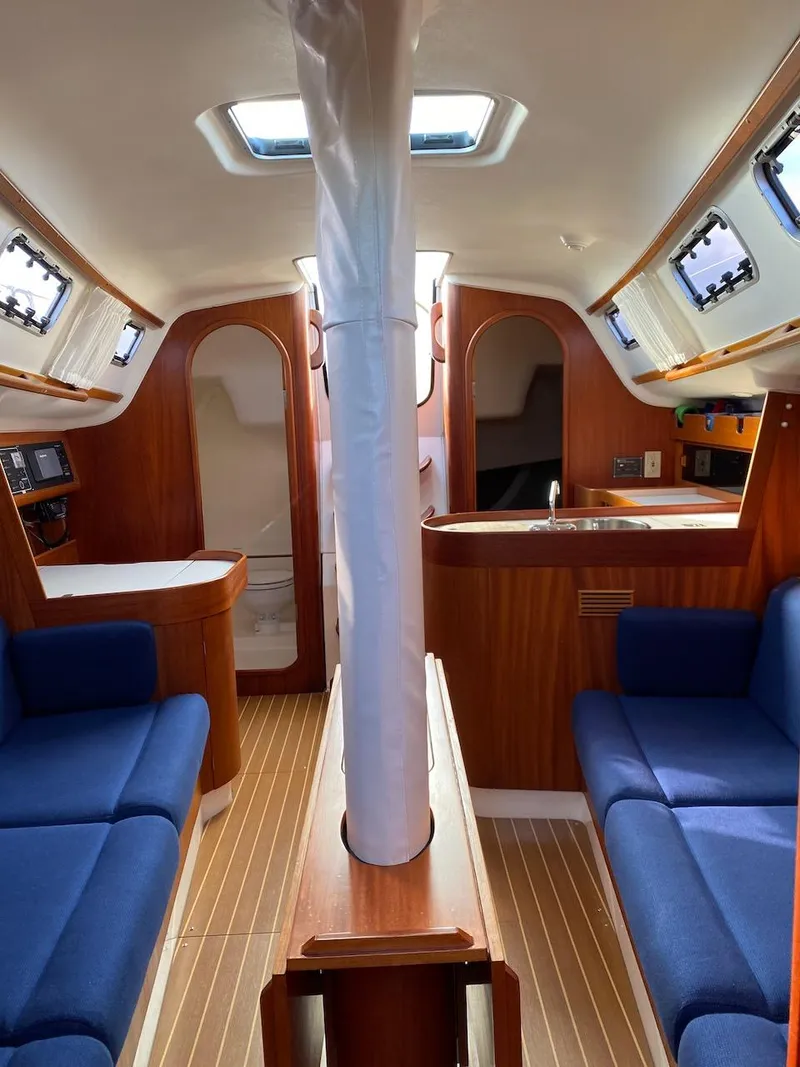 Slide: The Image of Interior of 2001 X-Yachts 332 sailboat with blue seating and wooden finishes. - 31