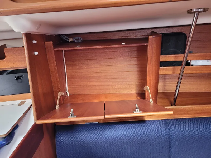 Slide: The Image of Wooden interior cabinet of a 2001 X-Yachts 332 sailboat, featuring foldable doors. - 32