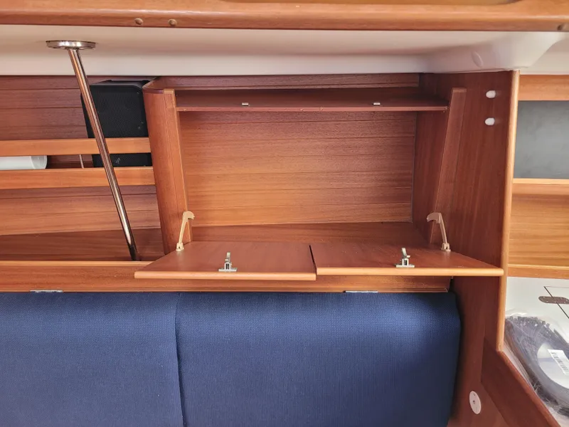 Slide: The Image of Interior of 2001 X-Yachts 332, featuring wooden cabinetry and blue upholstery. - 33