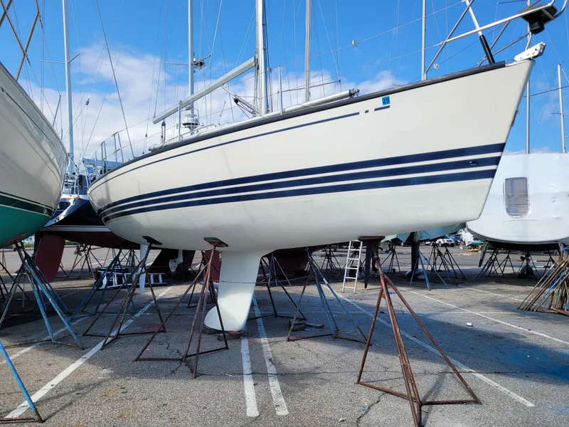 Slide: The Image of 2001 X-Yachts 332 sailboat on stands in a marina, clear sky background. - 4