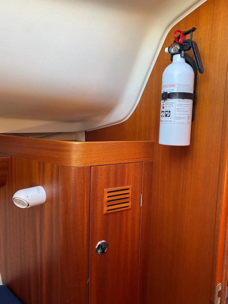 Slide: The Image of Interior of 2001 X-Yachts 332 with wooden paneling and mounted fire extinguisher. - 41
