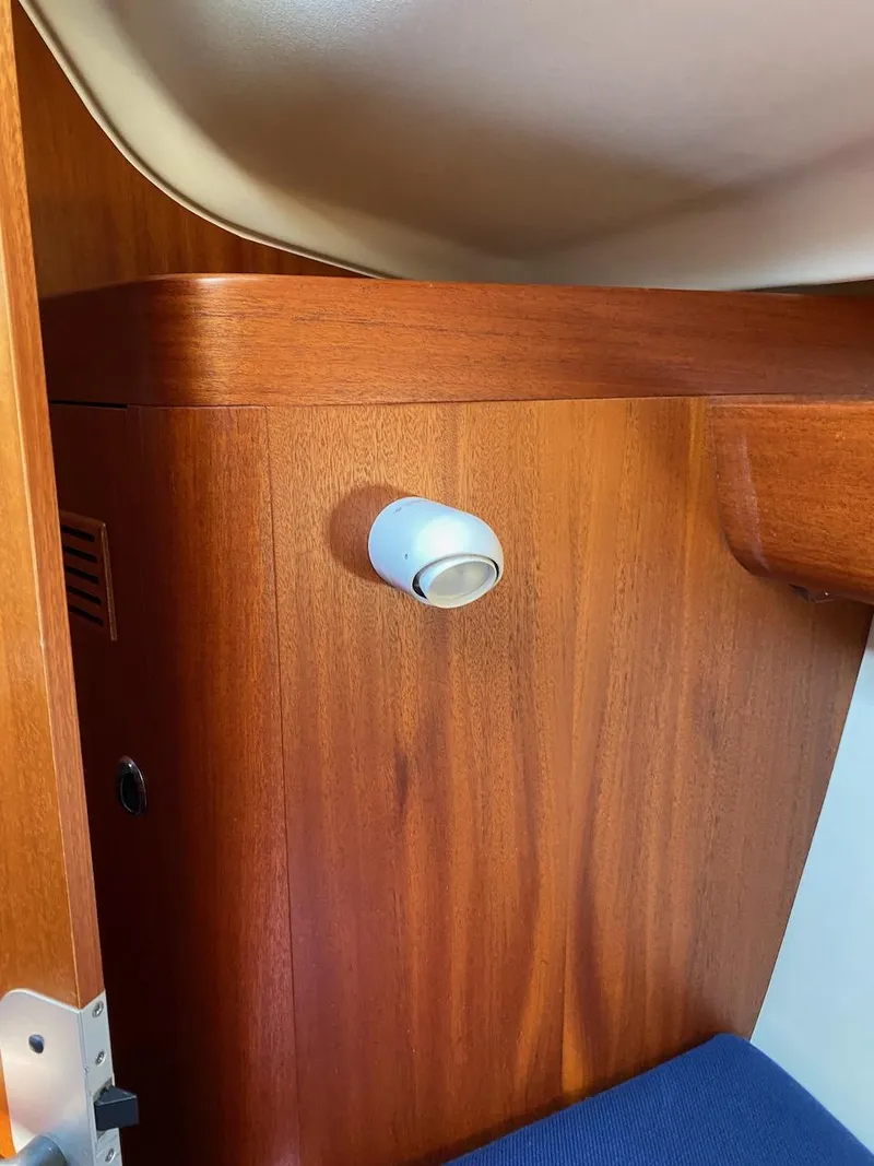 Slide: The Image of Wooden interior of 2001 X-Yachts 332 sailboat with spotlight and blue cushion. - 43