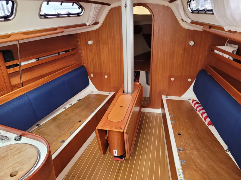 Slide: The Image of Interior of 2001 X-Yachts 332 sailboat with wooden finish and blue seating. - 45