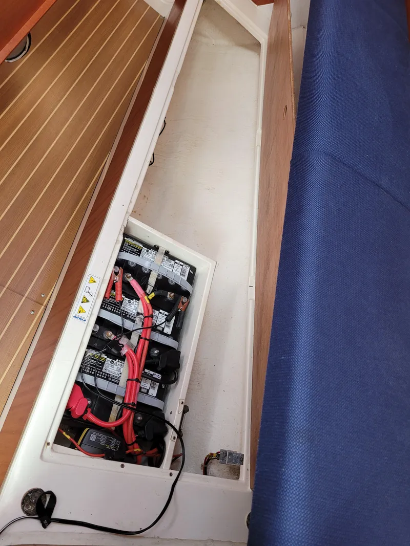 Slide: The Image of Battery compartment of a 2001 X-Yachts 332 sailboat, featuring organized wiring and storage. - 46