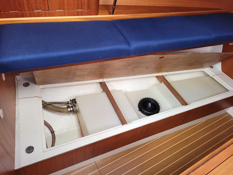 Slide: The Image of Interior view of a 2001 X-Yachts 332 sailboat, showcasing under-seat storage compartments. - 47