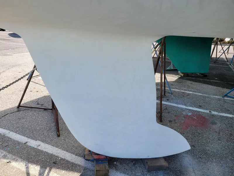 Slide: The Image of Keel of a 2001 X-Yachts 332 sailboat on a stand in a parking area. - 5