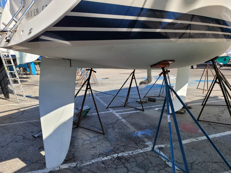 Slide: The Image of 2001 X-Yachts 332 sailboat on stands in a boatyard, showing keel and hull details. - 8