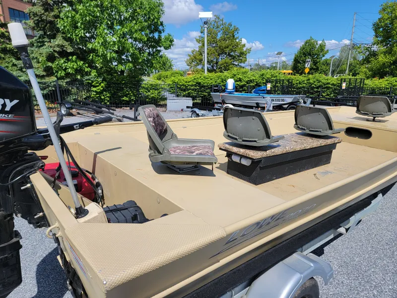 Slide: The Image of 2018 Lowe Roughneck 2070 Big River boat on trailer, featuring spacious deck and seating. - 4