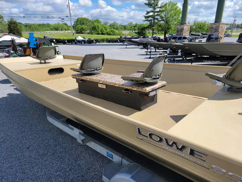 Slide: The Image of 2018 Lowe Roughneck 2070 Big River boat on trailer, featuring seating and open deck. - 6