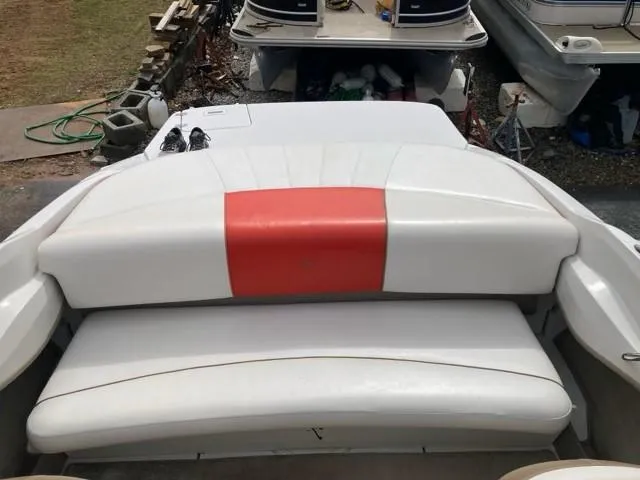 Slide: The Image of 2010 Four Winns H190 boat with white and red seating, docked outdoors. - 18