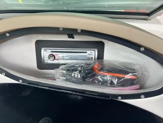 Slide: The Image of 2010 Four Winns H190 boat dashboard with stereo system and accessories. - 22