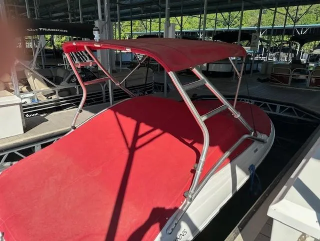 Slide: The Image of 2010 Four Winns H190 boat with red canopy docked in marina. - 4