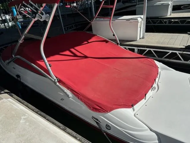 Slide: The Image of 2010 Four Winns H190 boat with red cover docked at marina. - 6