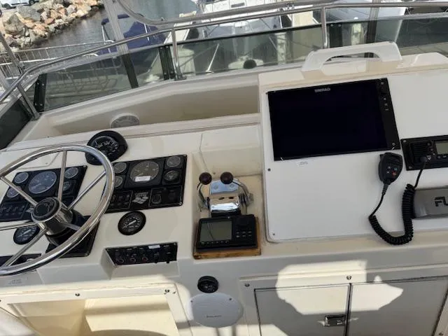 Slide: The Image of 1989 Egg Harbor 35 Sport Fisherman helm with steering wheel, gauges, and navigation equipment. - 11