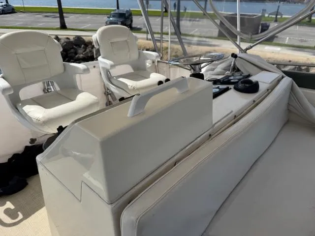 Slide: The Image of 1989 Egg Harbor 35 Sport Fisherman boat interior with white seating and control panel. - 17