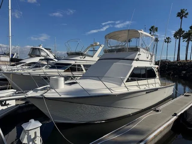Slide: The Image of 1989 Egg Harbor 35 Sport Fisherman docked at marina under clear blue sky. - 18