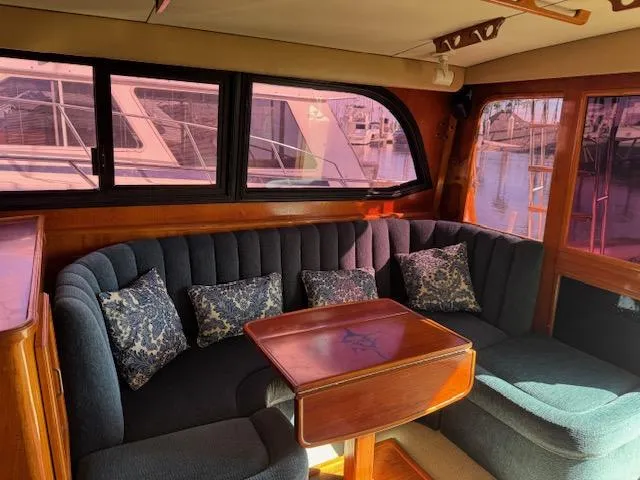Slide: The Image of 1989 Egg Harbor 35 Sport Fisherman interior with plush seating and wooden table. - 3