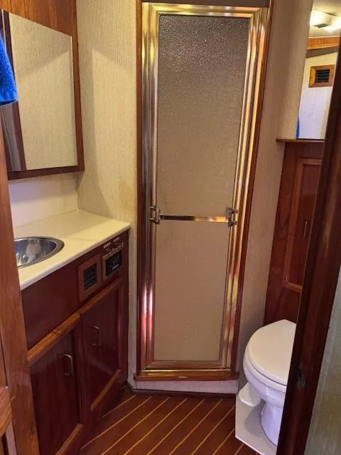 Slide: The Image of 1989 Egg Harbor 35 Sport Fisherman bathroom with shower, sink, and toilet. - 5