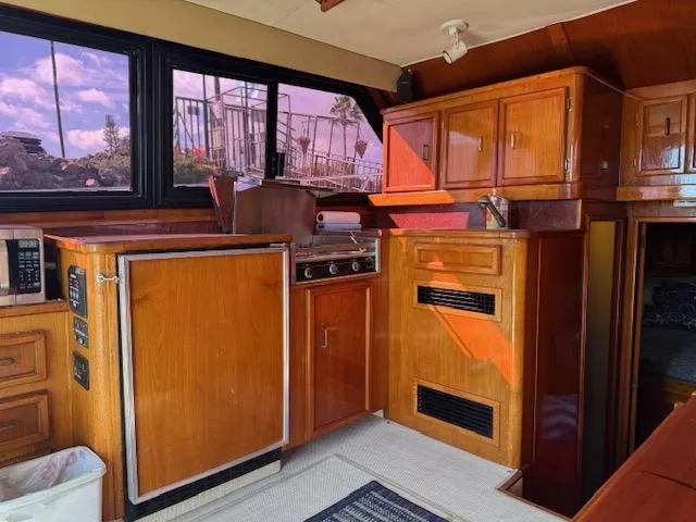 Slide: The Image of 1989 Egg Harbor 35 Sport Fisherman interior with wooden cabinetry and kitchen appliances. - 7