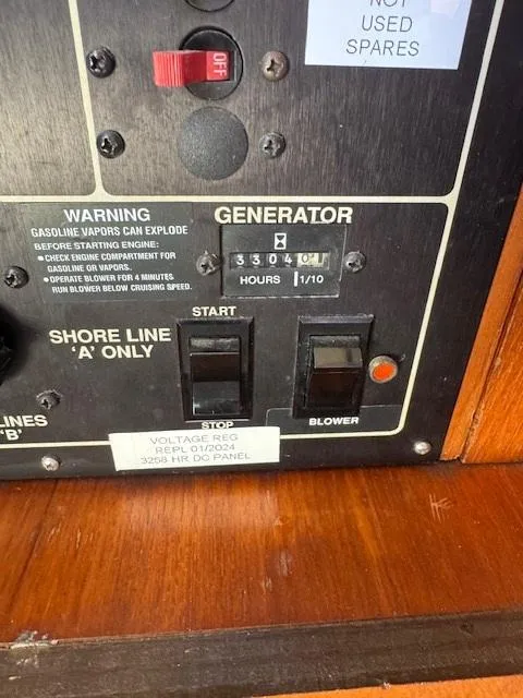 Slide: The Image of Control panel of a 1989 Egg Harbor 35 Sport Fisherman boat, showing generator hours. - 9