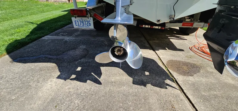Slide: The Image of 2017 Cobia 277 Center Console boat propeller on a driveway. - 12
