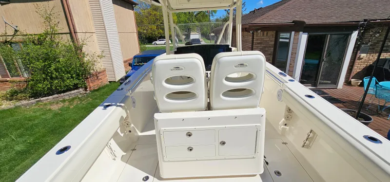 Slide: The Image of 2017 Cobia 277 Center Console boat interior with dual seats and storage compartments. - 15