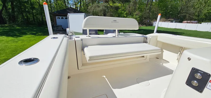 Slide: The Image of 2017 Cobia 277 Center Console boat interior with seating and storage. - 16