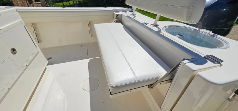 Slide: The Image of 2017 Cobia 277 Center Console boat interior with white seating and storage. - 18