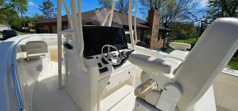 Slide: The Image of 2017 Cobia 277 Center Console boat interior with steering wheel and seating. - 21