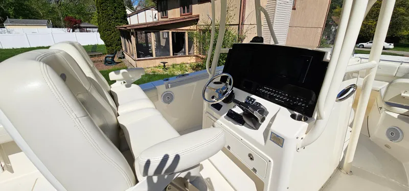 Slide: The Image of 2017 Cobia 277 Center Console boat interior with steering wheel and control panel. - 22