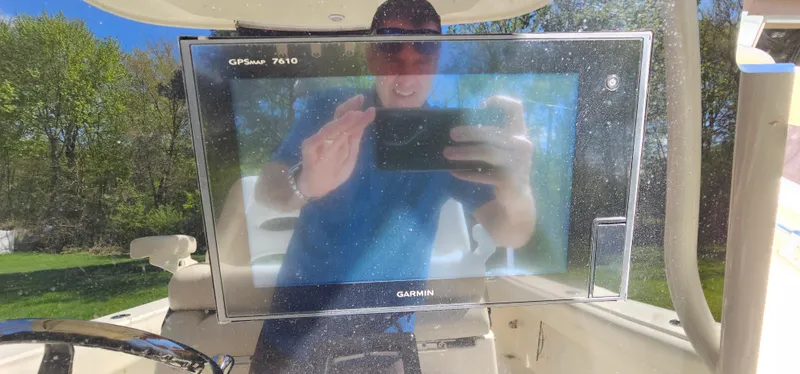 Slide: The Image of 2017 Cobia 277 Center Console with Garmin GPS display, reflecting a person taking a photo. - 25