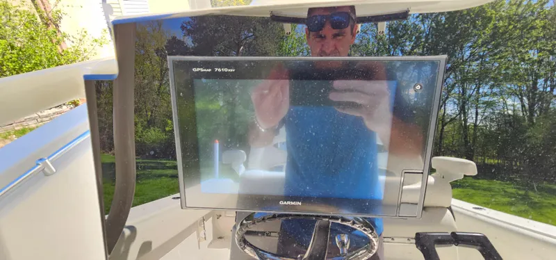 Slide: The Image of 2017 Cobia 277 Center Console with Garmin GPS display and reflection of a person. - 26